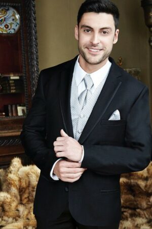 A model wears the black infinity tuxedo with platinum accessories