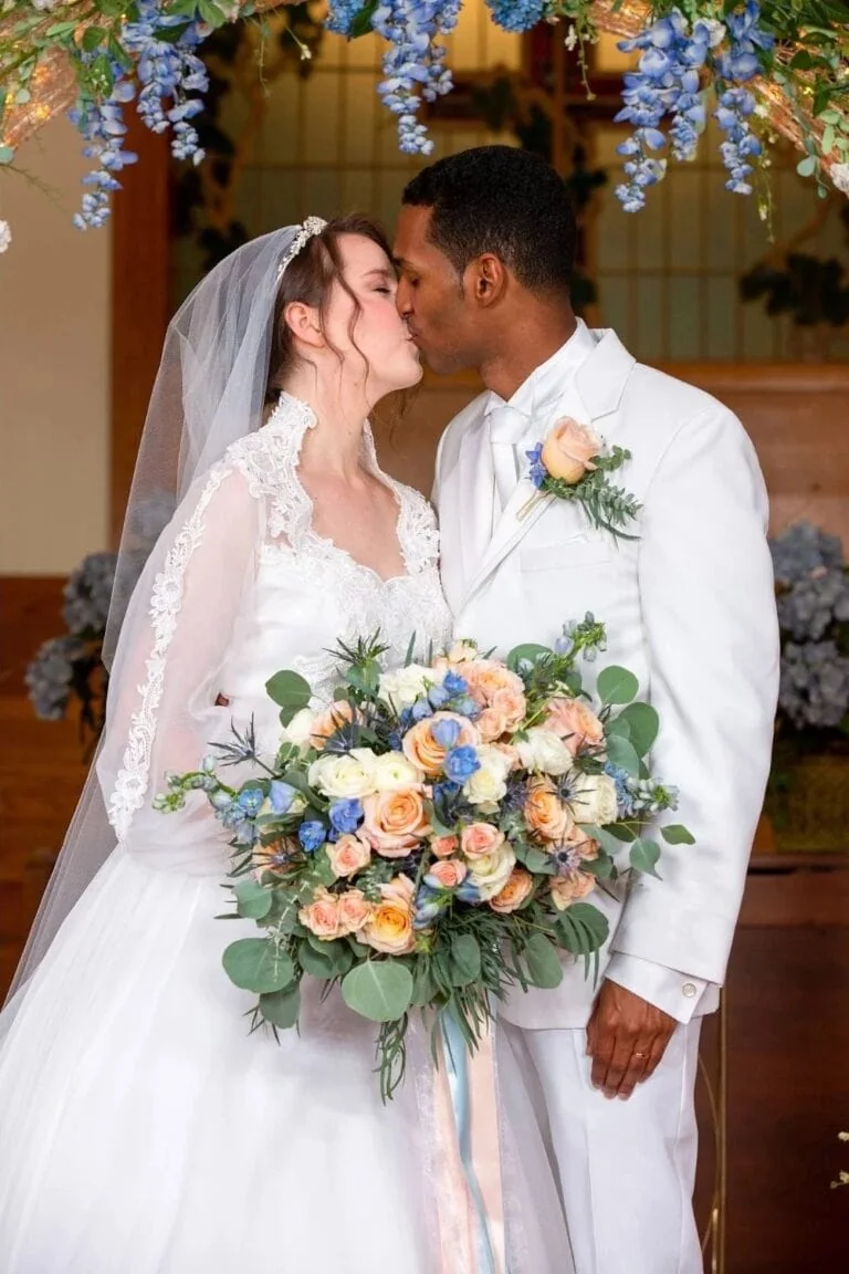 groom in white madison tuxedo rental with bride