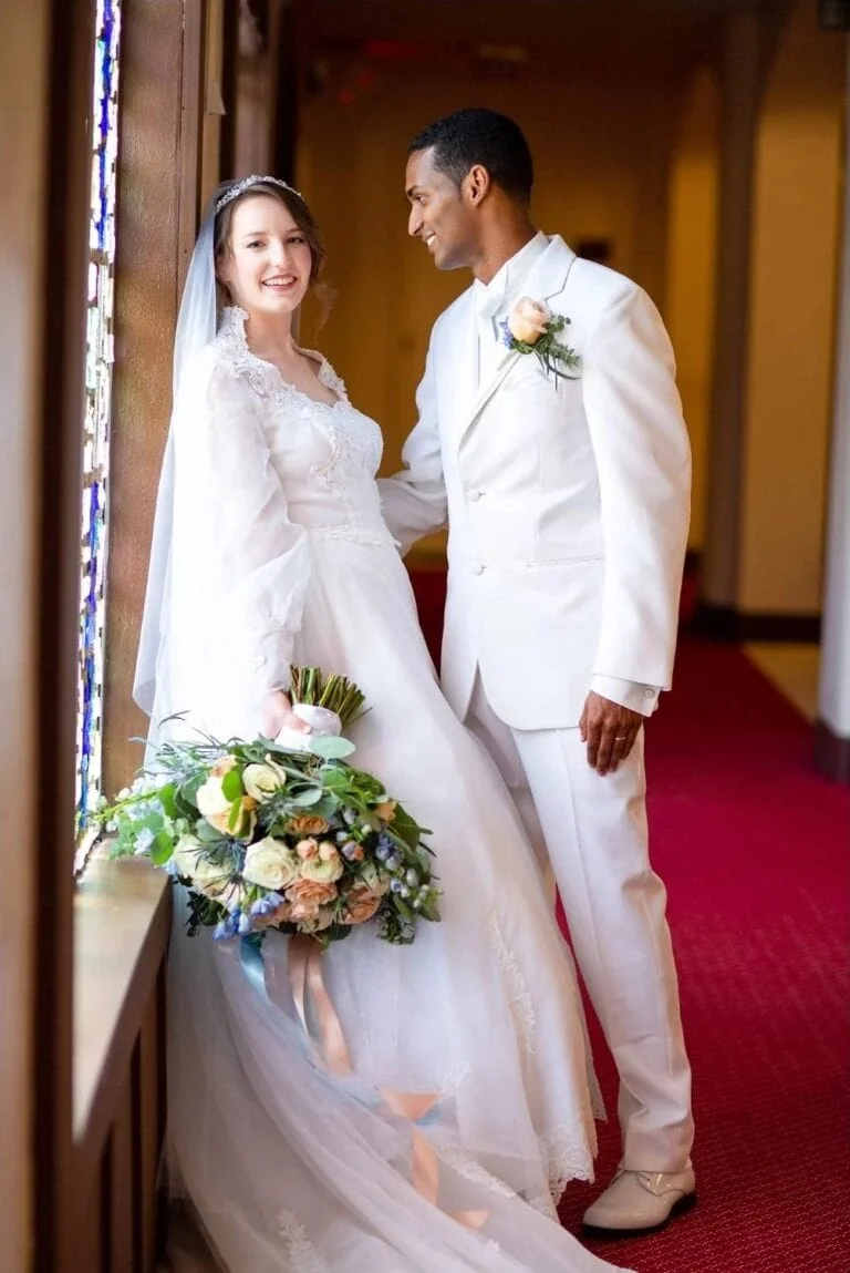 groom in white madison tuxedo rental with bride