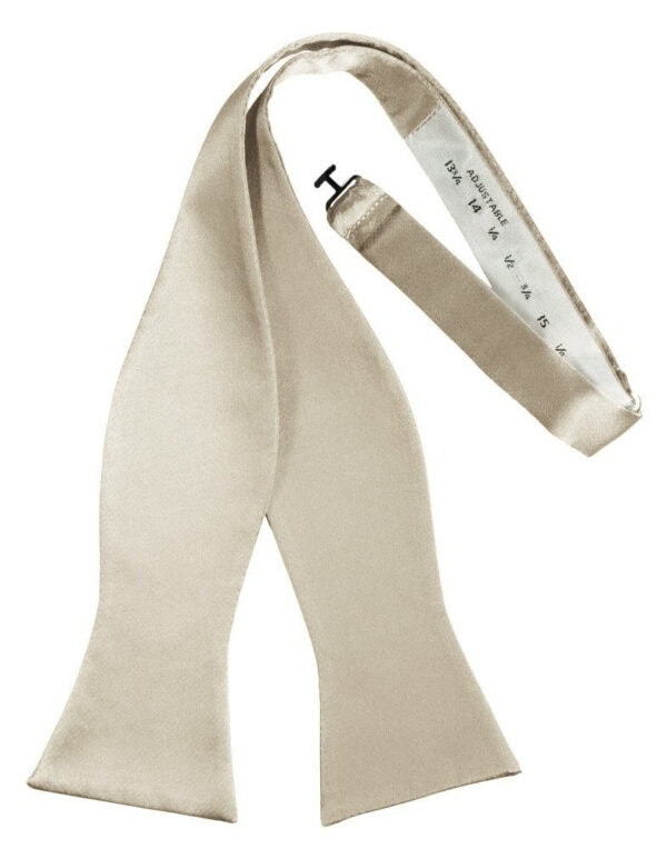 Beige necktie with a silver measuring tape along the inner edge.