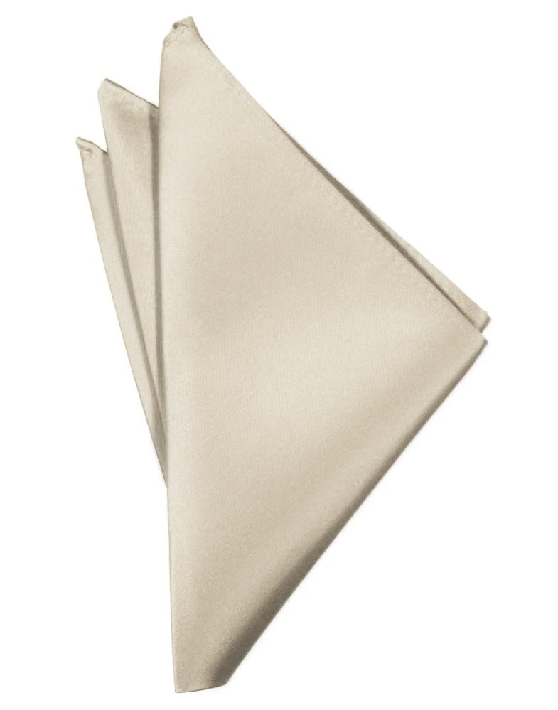 Three beige cloth napkins folded and layered in a diagonal fan shape.