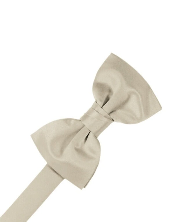 Beige fabric bow tied at its center with a long ribbon extending to the left, on a white background