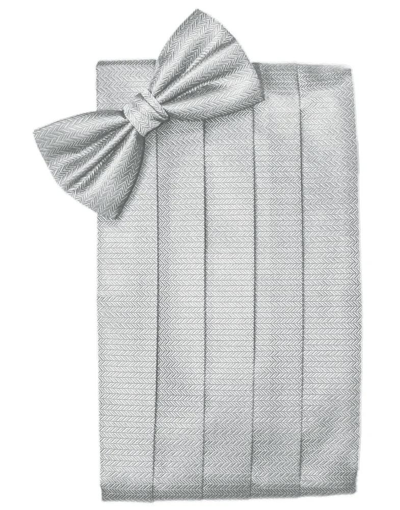Gray herringbone-patterned blanket neatly folded with a large matching bow on top.