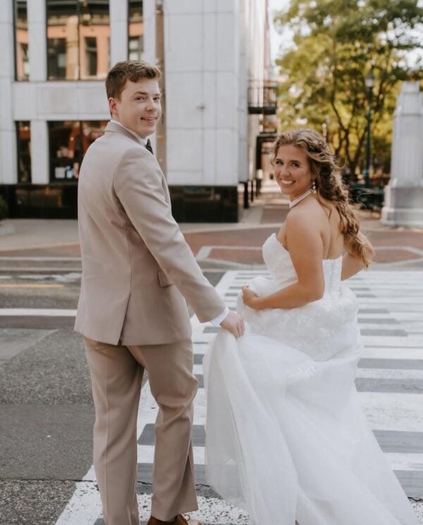 groom walking in the street with bride