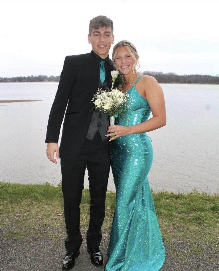young man wearing black mirage tuxedo to prom