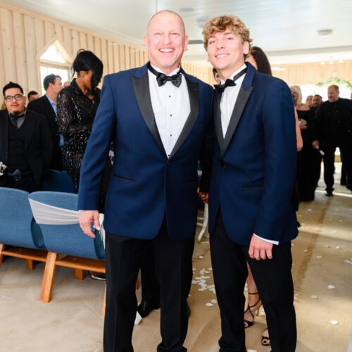 two men wearing navy and black tuxedo rentals at wedding