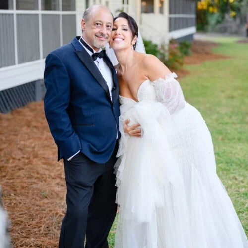 bride and her father smiling at wedding