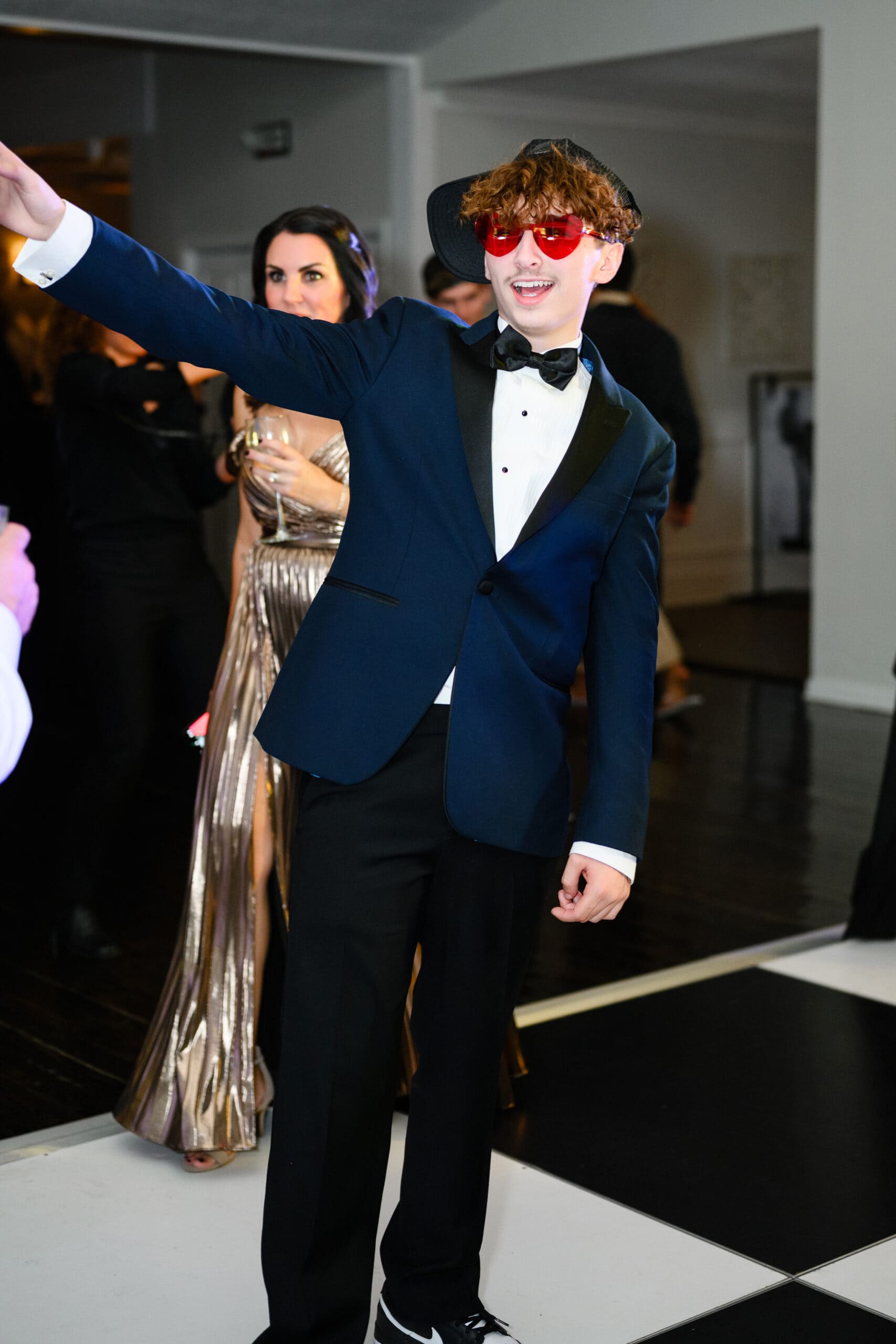 Shannon and Eddie Wedding Day | National Tuxedo Rentals young man wearing navy tuxedo rental