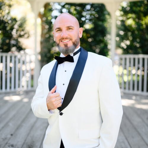 groom wearing white london tuxedo rental