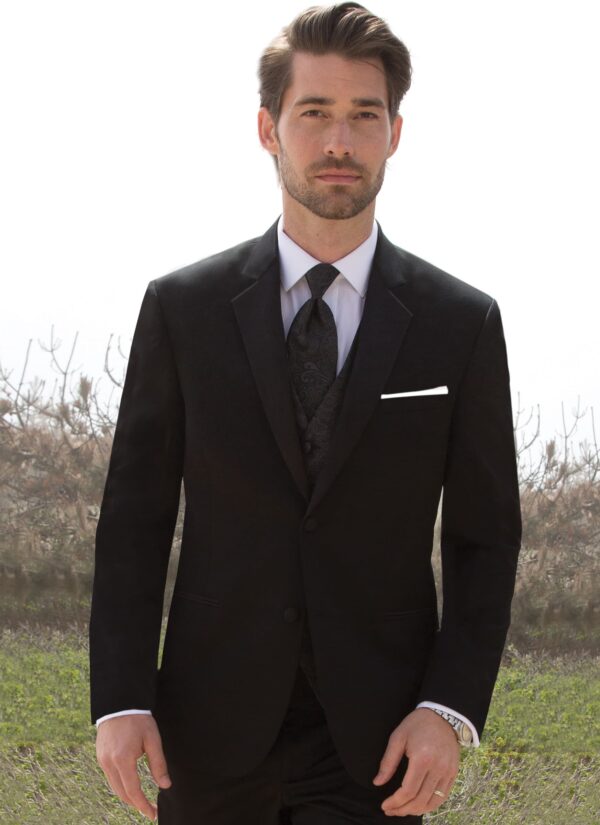 A man poses while wearing the black Desire tuxedo from Michael Kors.