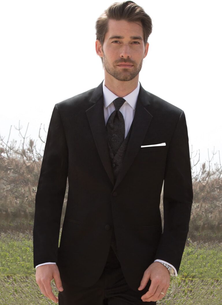 A man poses while wearing the black Desire tuxedo from Michael Kors.