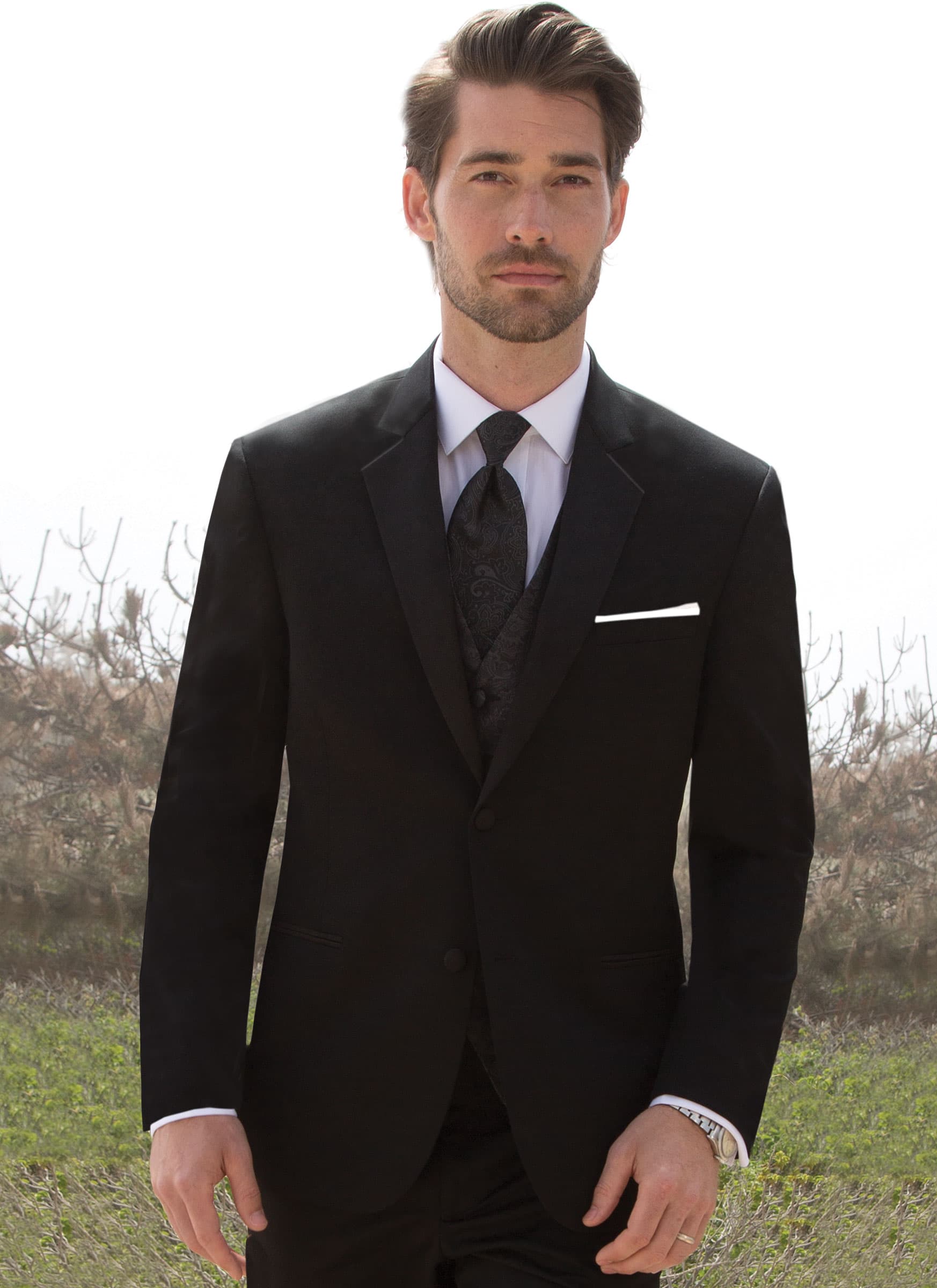 A man poses while wearing the black Desire tuxedo from Michael Kors.