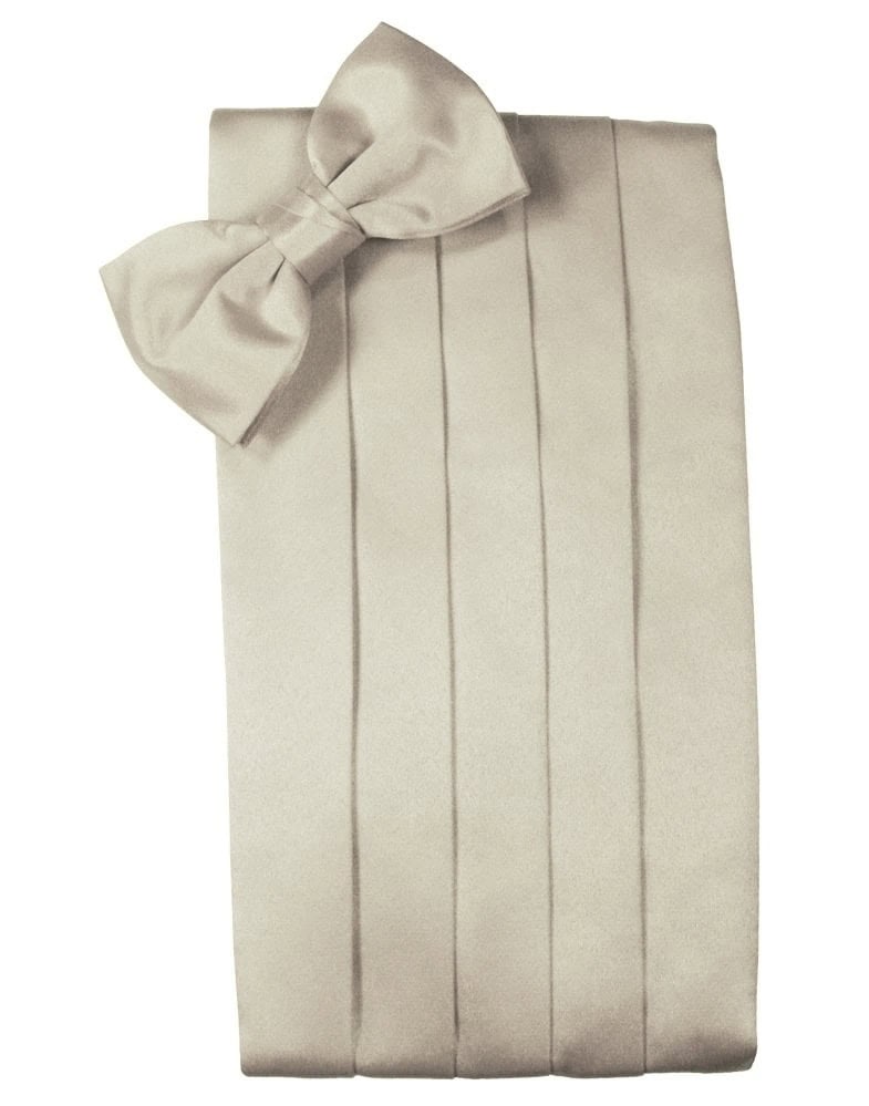 Beige gift box with a large satin bow at the top-left corner and vertical ribbon folds along the sides.