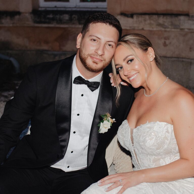 groom in black tuxedo rental with bride