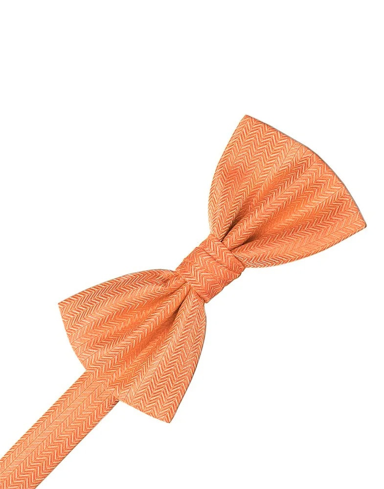 Orange bow tie with a chevron pattern tied in a knot on a white background.