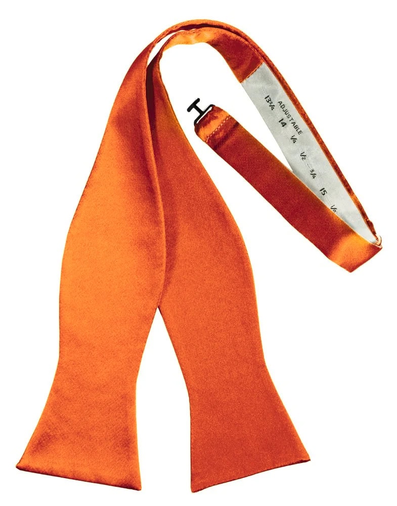 Orange fashion scarf with a white measuring-tape-like inner edge, draped in a loose loop for decorative wear.