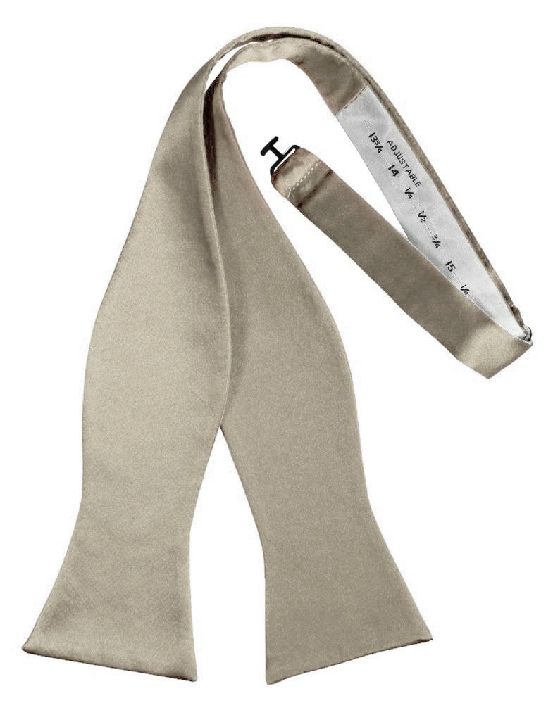 Beige satin scarf draped with a white measuring tape showing measurement marks.