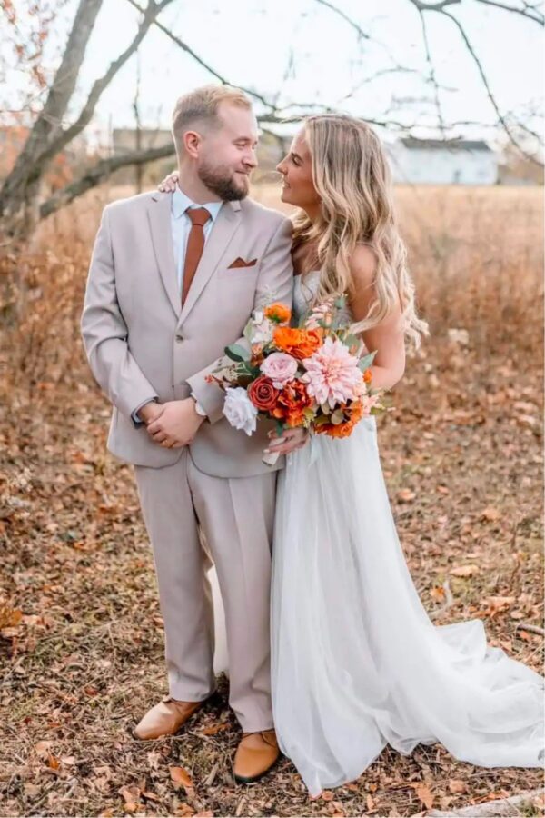 groom wearing his tan suit rental