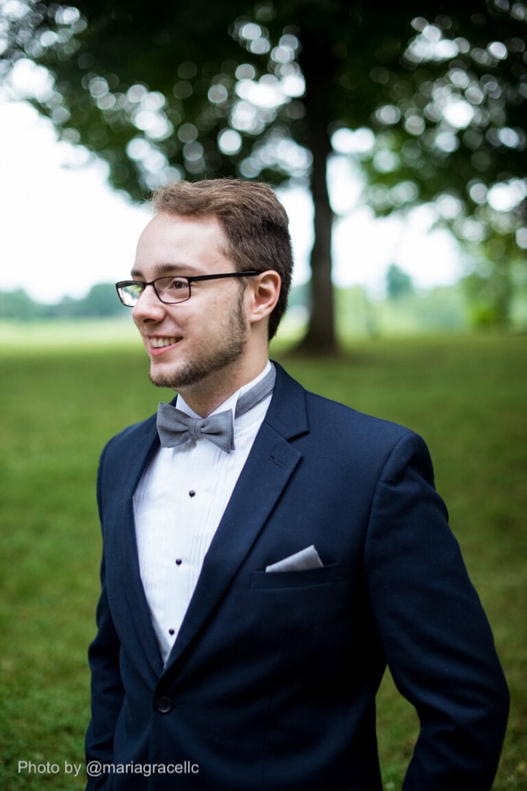 a man wearing a blue suit rental outside