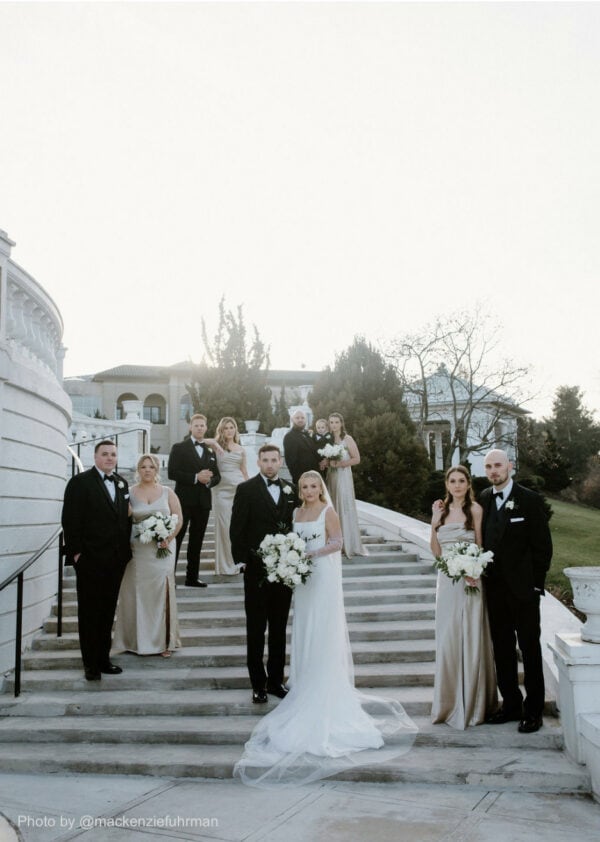 wedding party standing on outdoor stairways posing for photos