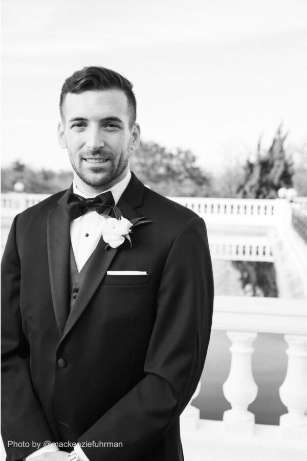 groom wearing a black and white tuxedo rental by national tuxedo rentals