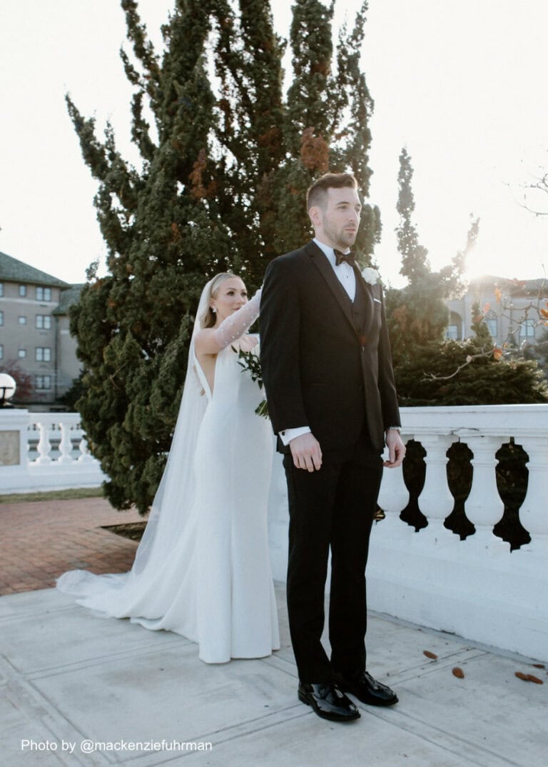 bride tapping her groom on the shoulder before their first look
