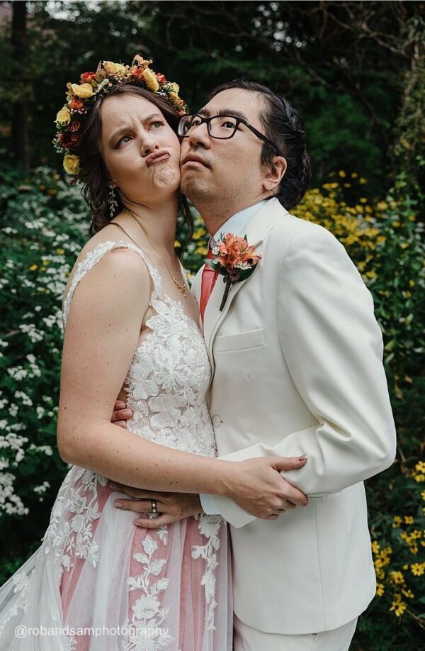 bride and groom making silly faces in a wedding photo outside