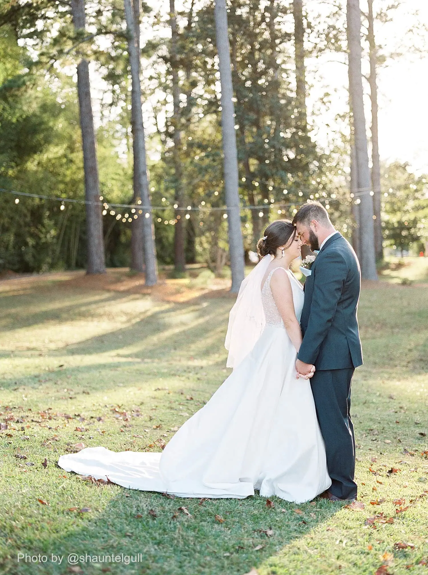 groom wearing a dark gray tuxedo rental with bride