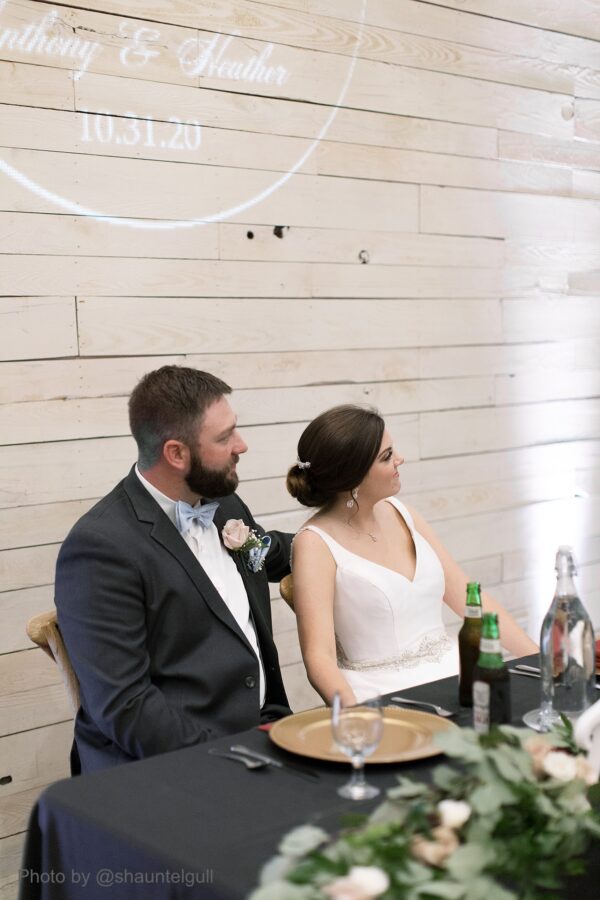bride and groom sitting at table at reception