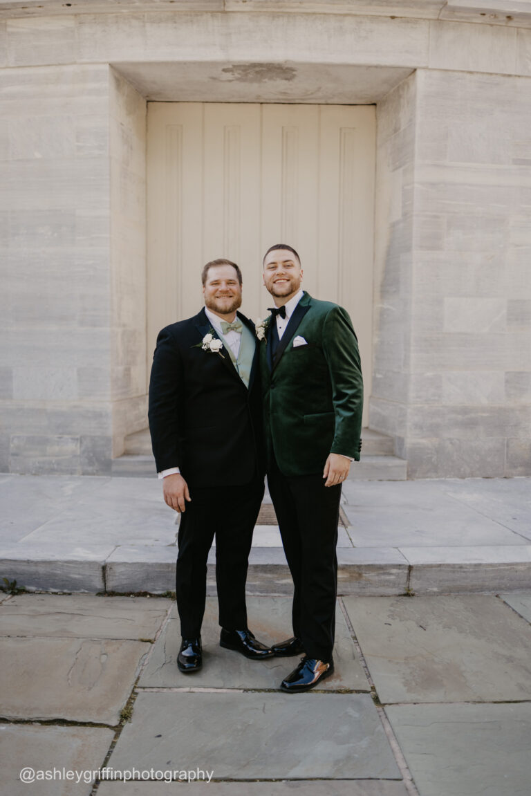 groom and his groomsman wearing tuxedo rentals smiling for photo
