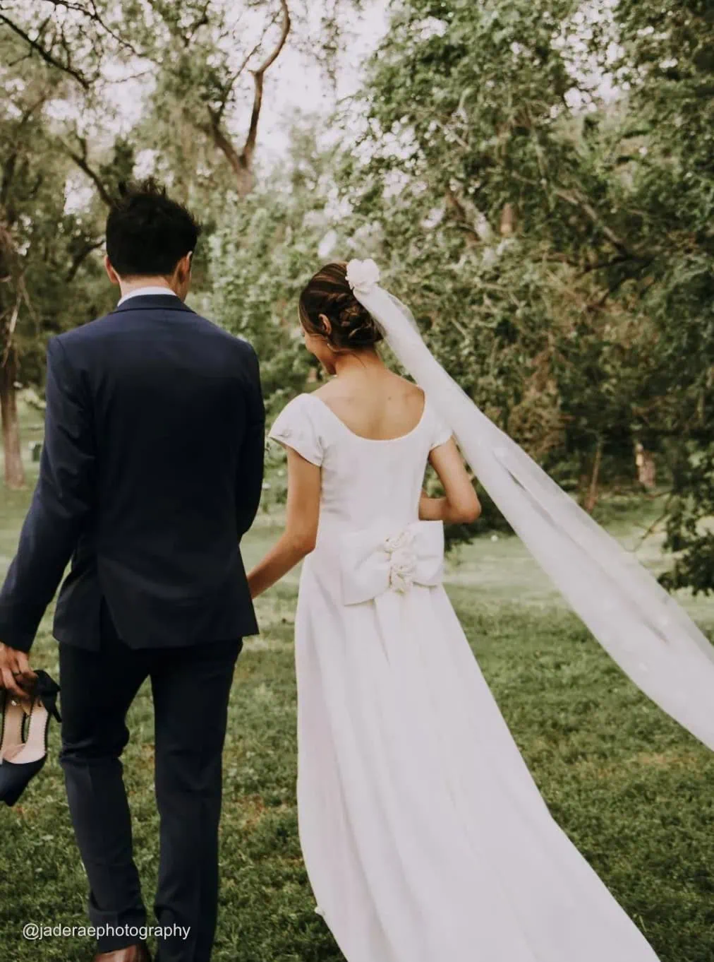 photo taken from behind the bride and groom walking outside after wedding