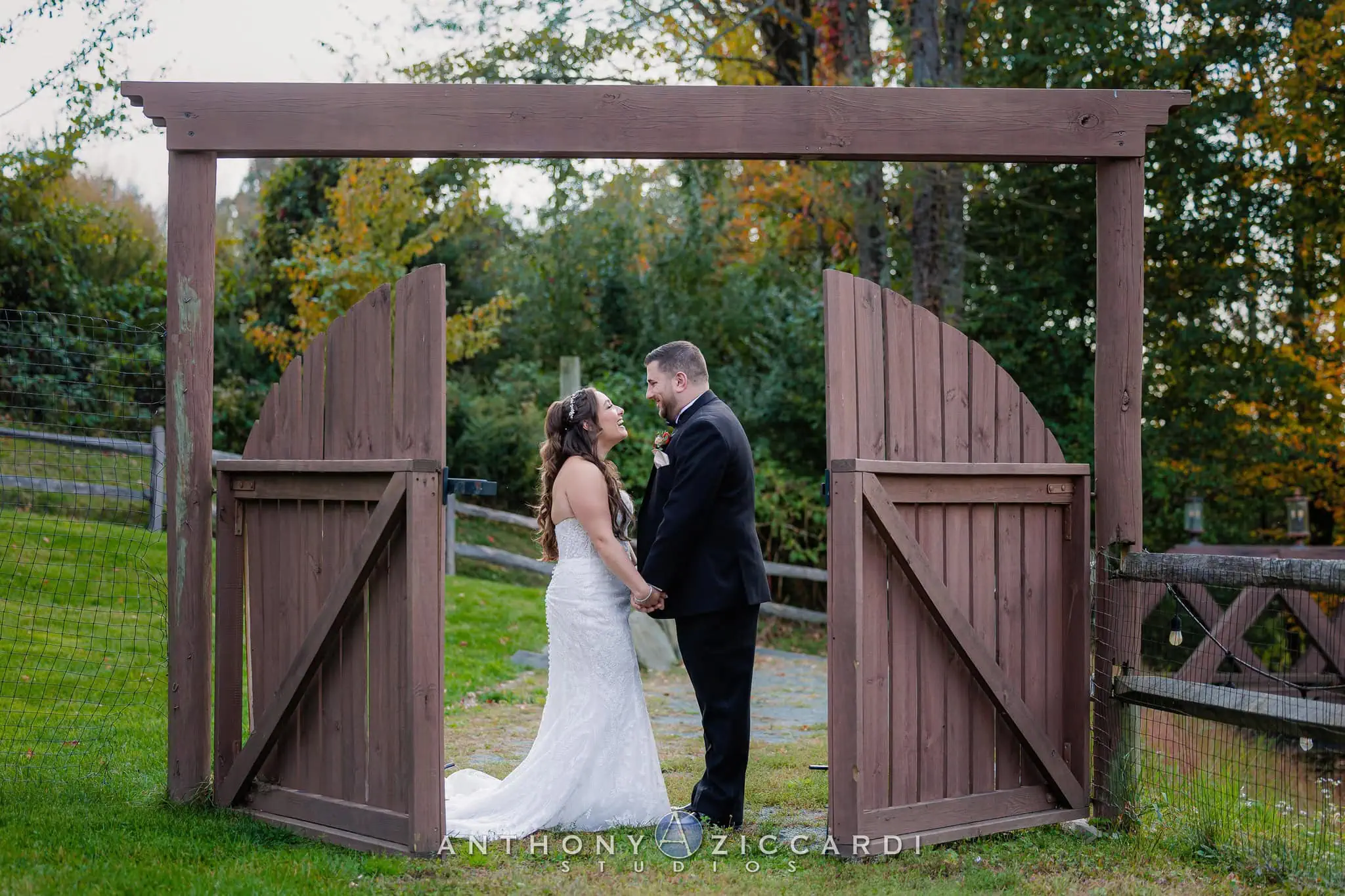 wedding couple standing between bark doors for photoshoot