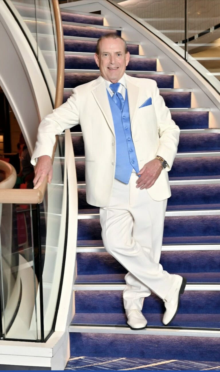 man wearing a ivory tuxedo rental on a cruise ship