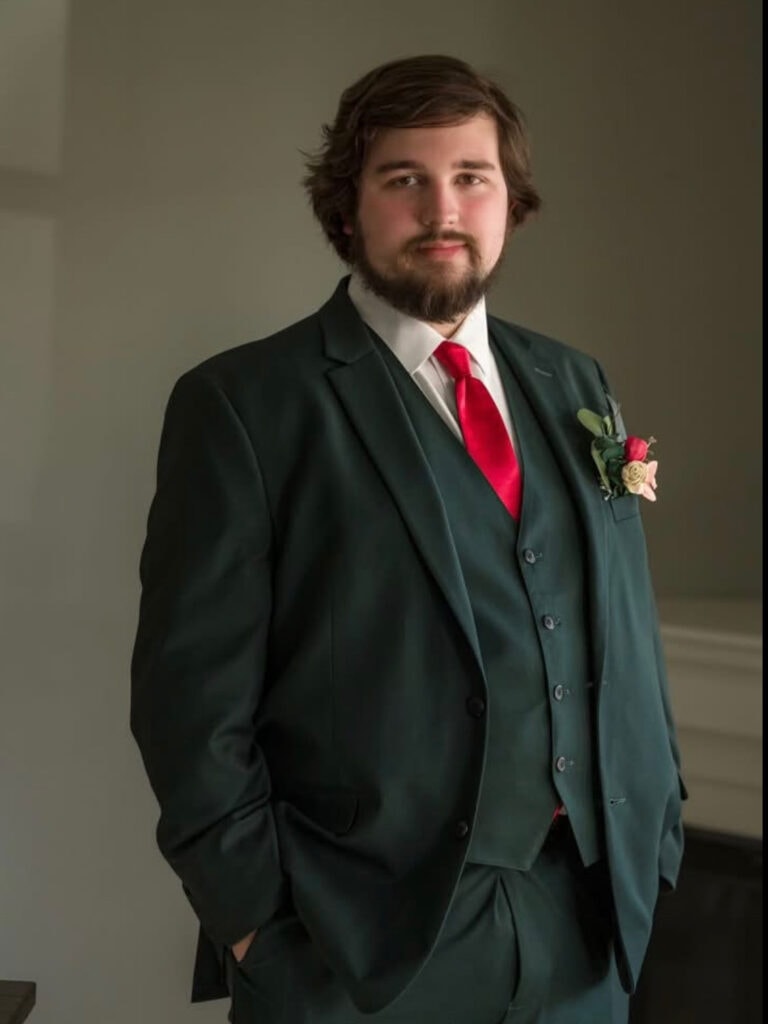 greensuitgroom | National Tuxedo Rentals groom wearing green suit rental with red tie