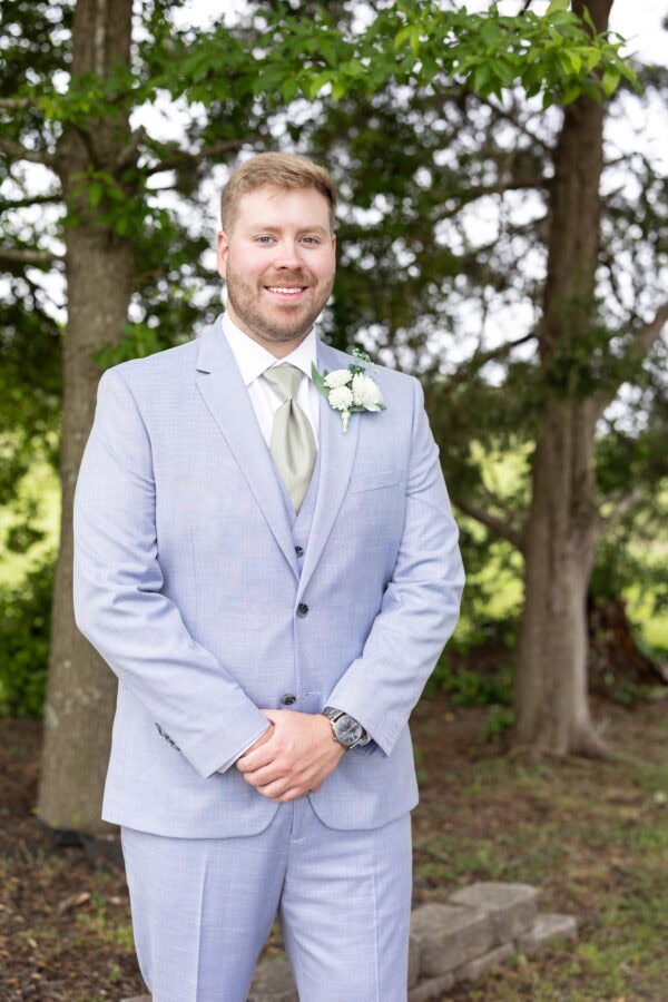 C0DB11CF-9A68-4B4B-978F-3F03AC720EB3 | National Tuxedo Rentals groom wearing oxford blue suit rental