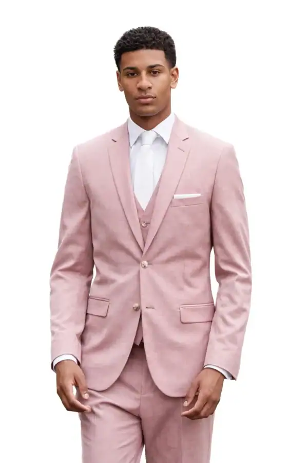 Man wearing a light pink suit with a white shirt and tie, standing against a white background.