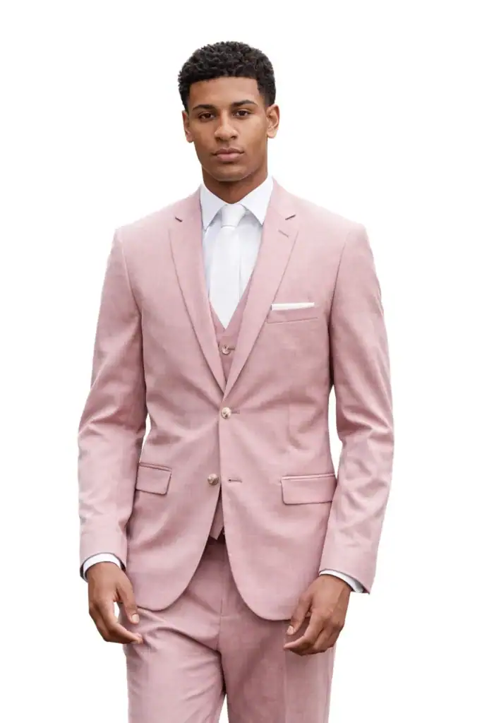 Man wearing a light pink suit with a white shirt and tie, standing against a white background.