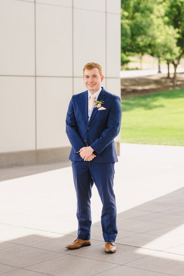 solo picture of groom in blue suit rental