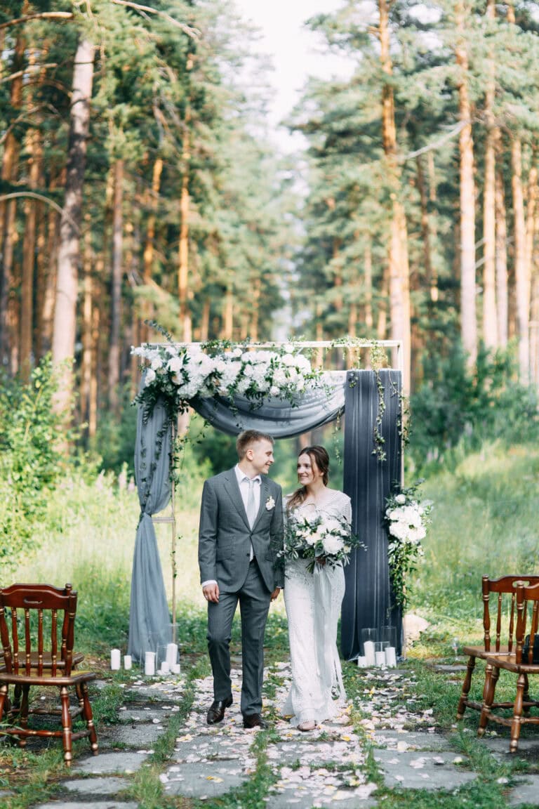 wedding couple walking down aisle in grey suit