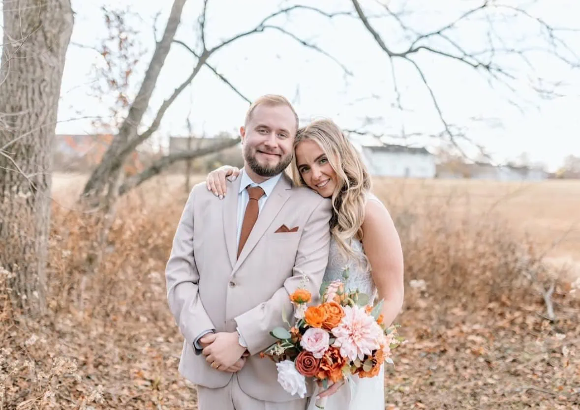 groom sin tan suit rental with bride in woods