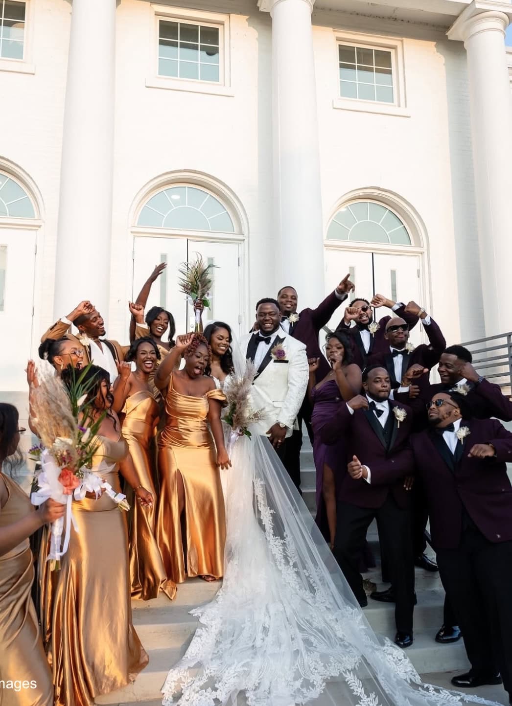 wedding party on stairs outside of venue