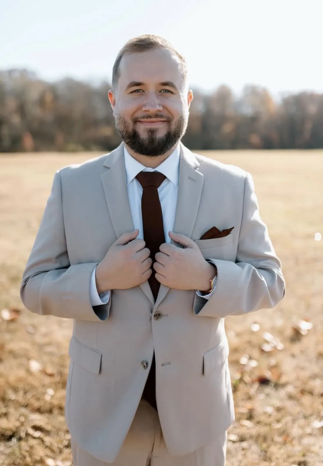 Screenshot grooms wearing a tan suit rental