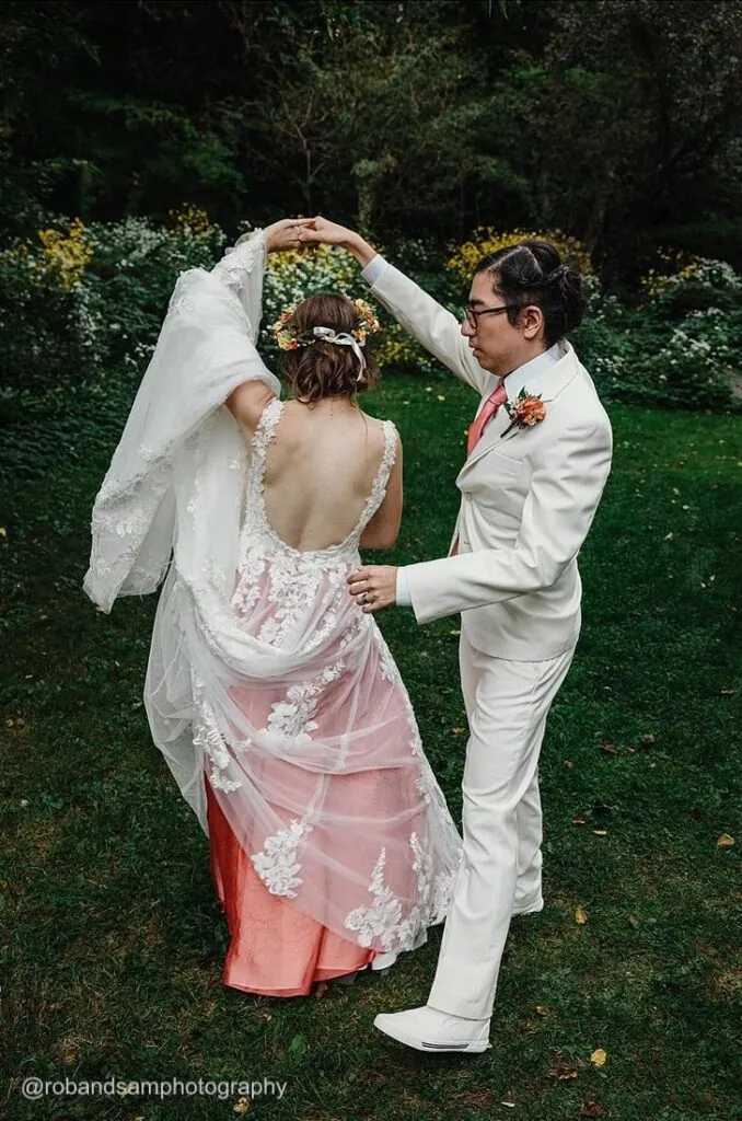 groom spinning bride outside