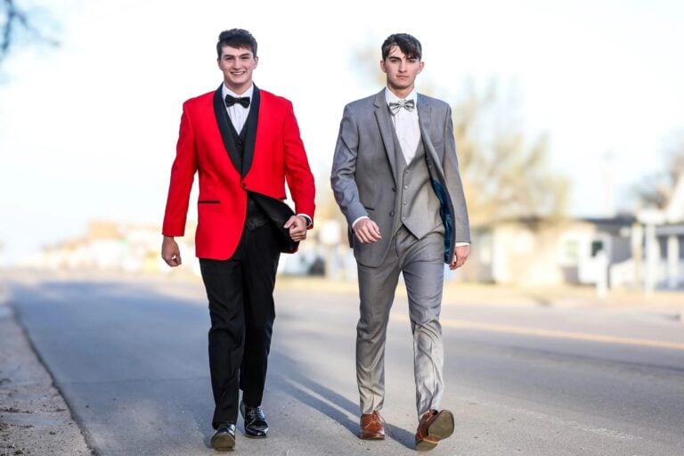 PROMCUSTOMER | National Tuxedo Rentals two friends walking in tuxedo rentals before prom
