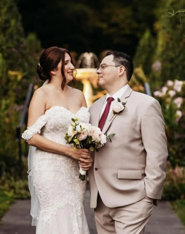 groom in a tan suit rental with bride at outdoor fall wedding