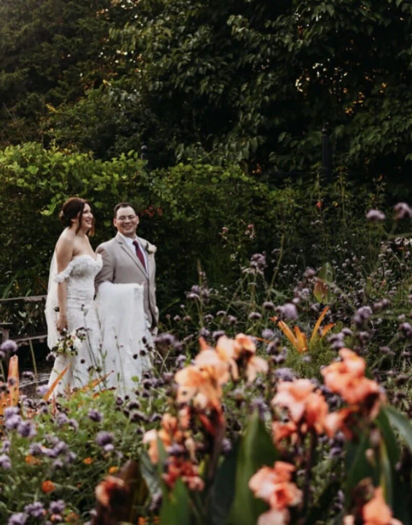 groom in a tan suit rental with bride at outdoor fall wedding