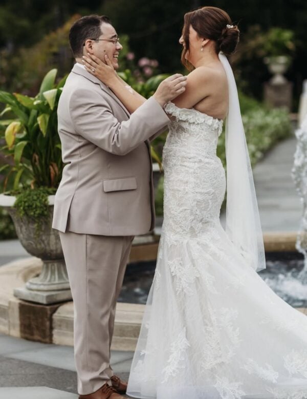 groom in a tan suit rental with bride at outdoor fall wedding