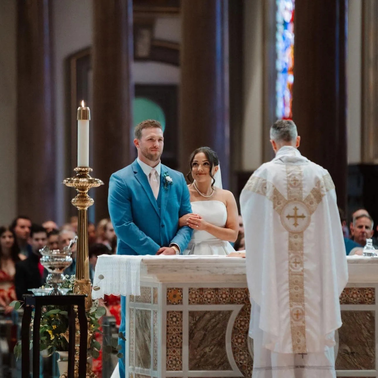 eg-wedding1 groom wearing marine blue suit rental standing at alter with bride at