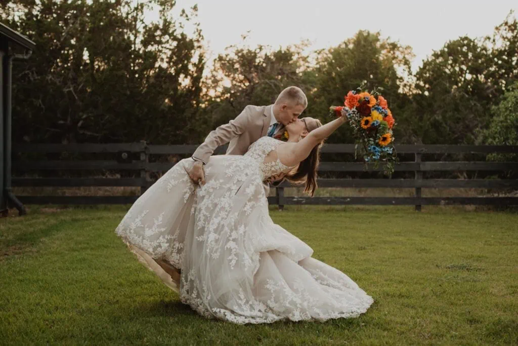 groom dipping bride after wedding