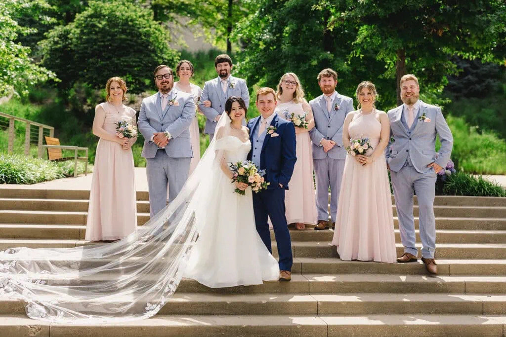 bridal party posing on stairs outdoors